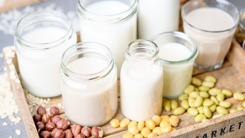 Verschiedne Gläser mit Ersatz-Milch auf einem Tablett und verschiedene Zutaten wie Mandeln, Nüsse, Erbsen. | Bild: picture alliance / dpa Themendienst | Zacharie Scheuer Verschiedne Gläser mit Ersatz-Milch auf einem Tablett und verschiedene Zutaten wie Mandeln, Nüsse, Erbsen.