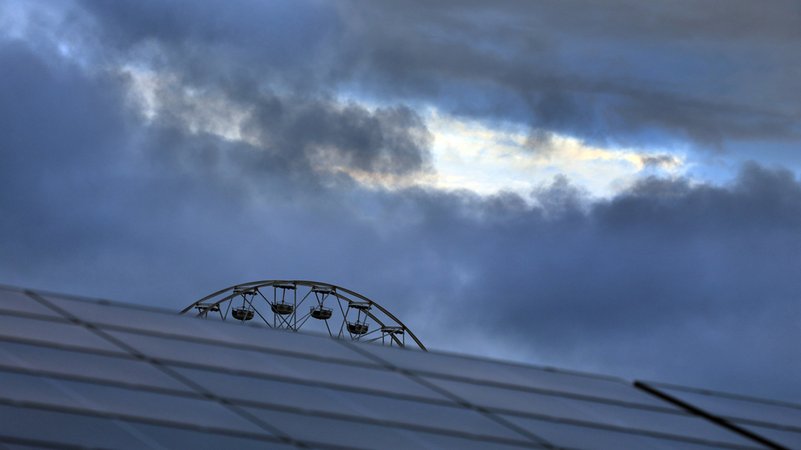 Das Riesenrad des Freizeitparks Allgäu Skyline Park, steht am frühen Morgen vor wolkenüberzogenen Himmel hinter den Paneelen einer Solaranlage. | Bild: dpa-Bildfunk/Karl-Josef Hildenbrand Das Riesenrad des Freizeitparks Allgäu Skyline Park, steht am frühen Morgen vor wolkenüberzogenen Himmel hinter den Paneelen einer Solaranlage.