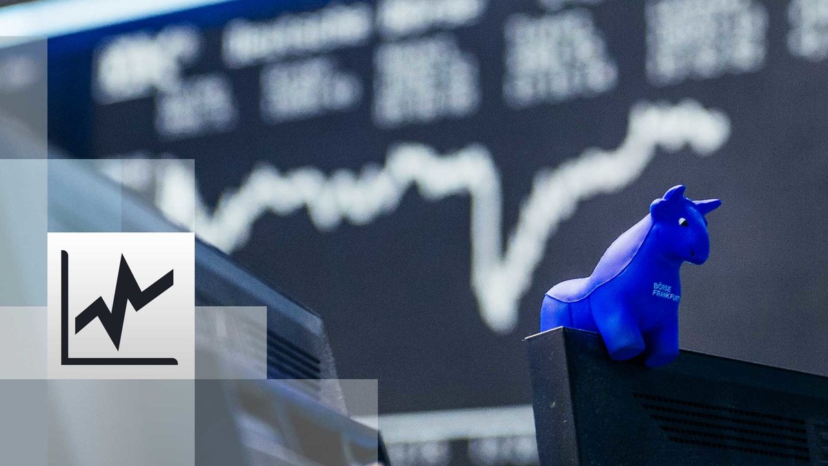 Blauer Stier aus Gummi sitzt auf der oberen Kante eines Bildschirmes, im Hintergrund die Kurstafel der Börse