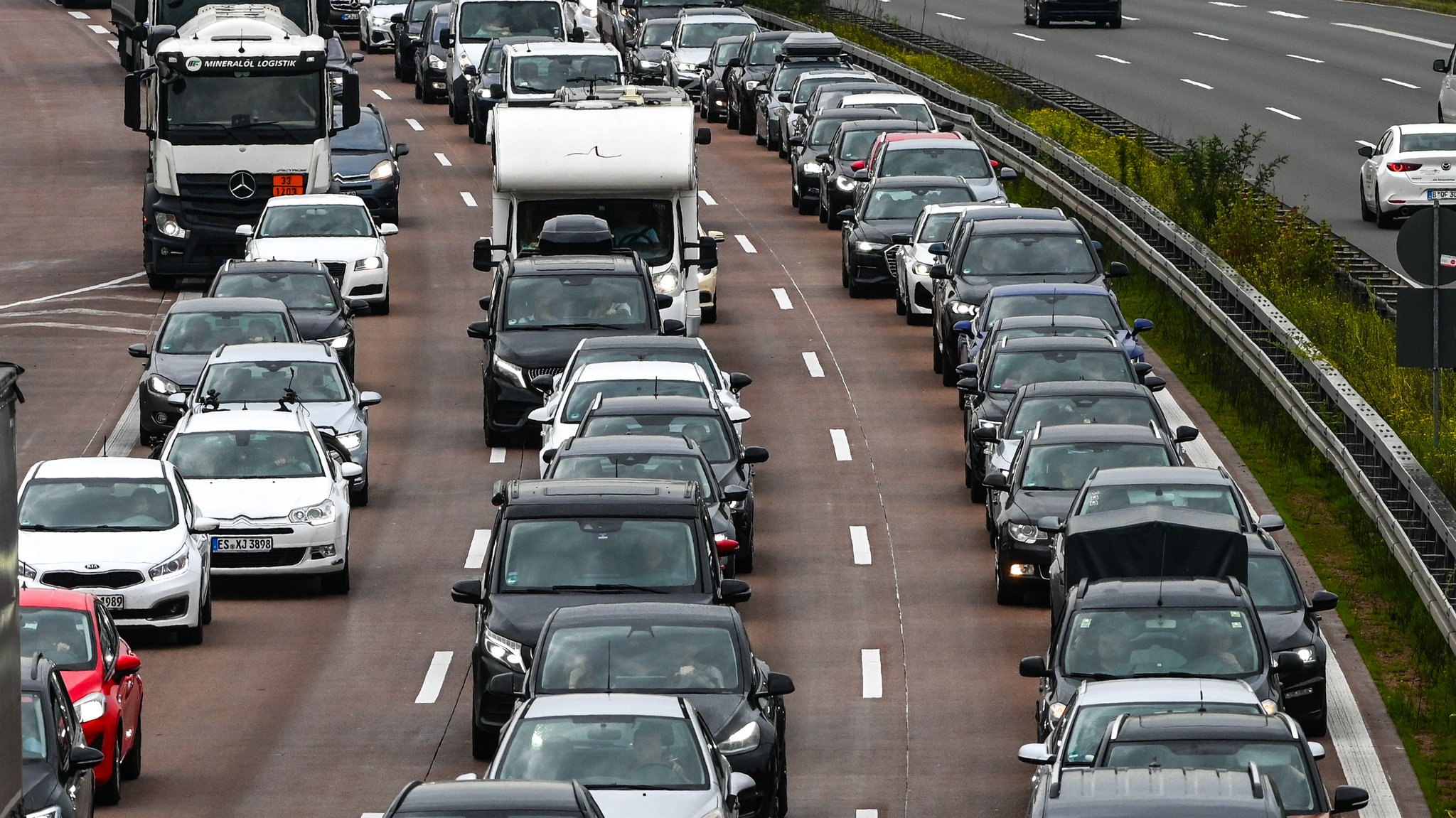 Viele Autos stehen auf einer dreispurigen Autobahn im Stau.