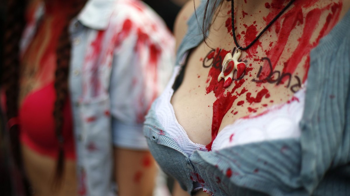 Frauen in Südamerika haben sich bei einer Demonstration gegen Femizid mit künstlichem Blut beschmiert.