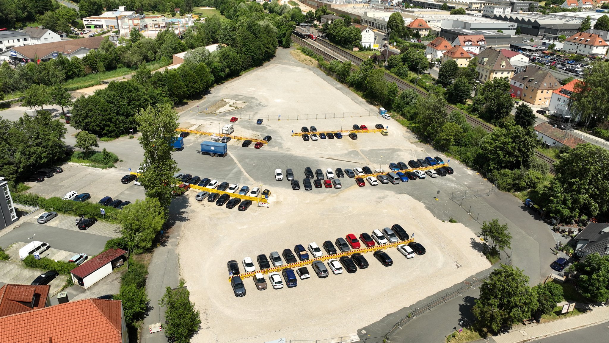 Eine Drohnenaufnahme zeigt einen Parkplatz von oben, umringt von vielen Bäumen. | Bild: BR/Michael Böhm Eine Drohnenaufnahme zeigt einen Parkplatz von oben, umringt von vielen Bäumen.