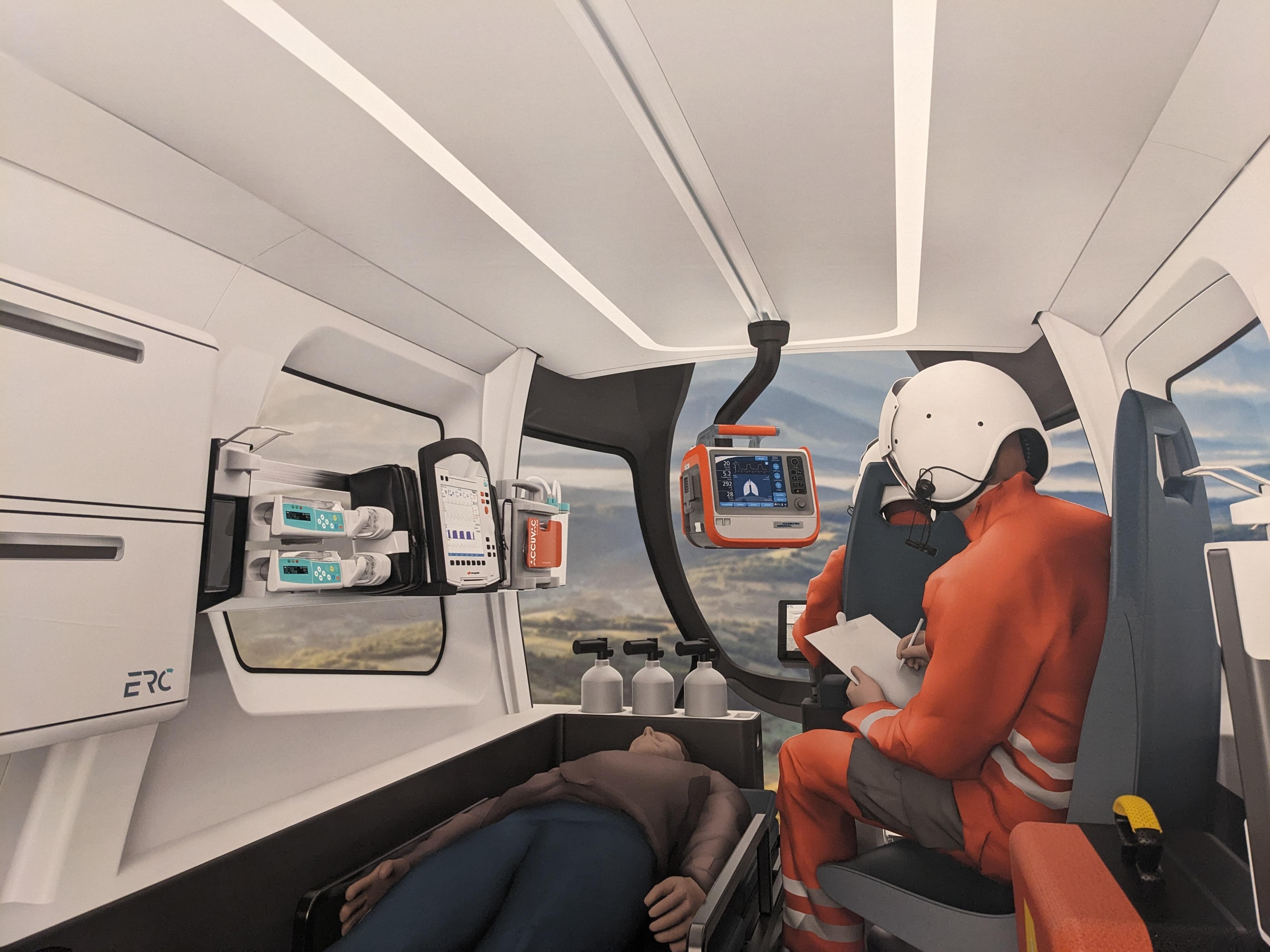 Eine digital erzeugte Abbildung eines Flugtaxis, in dem ein Patient transportiert und währenddessen von einem Notarzt versorgt wird.