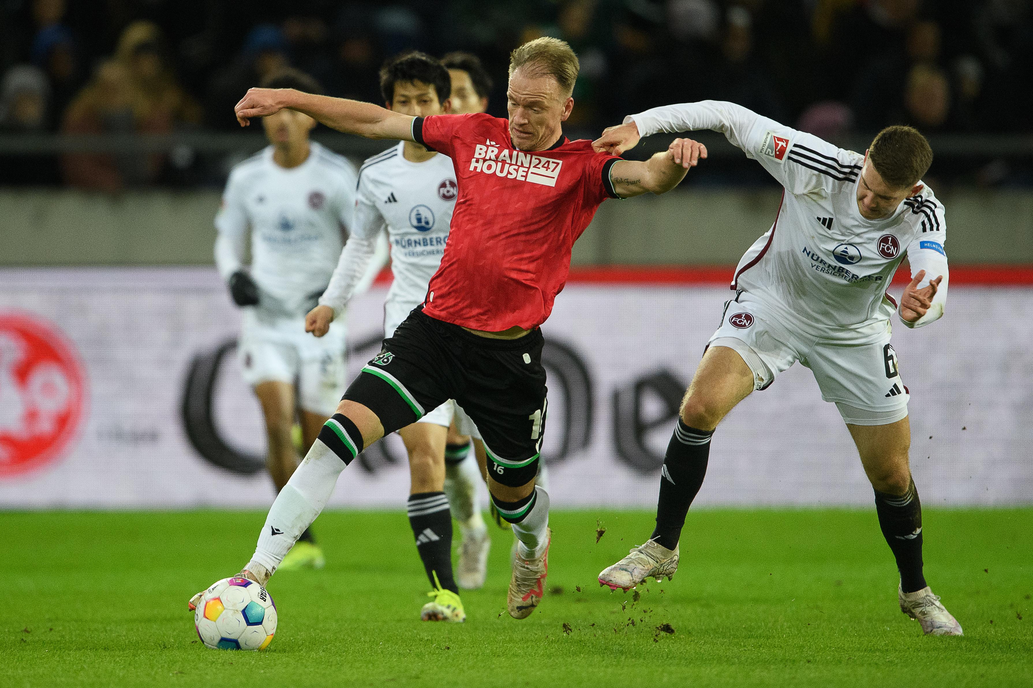 Hannovers Havard Nielsen (l) spielt gegen Nürnbergs Florian Flick