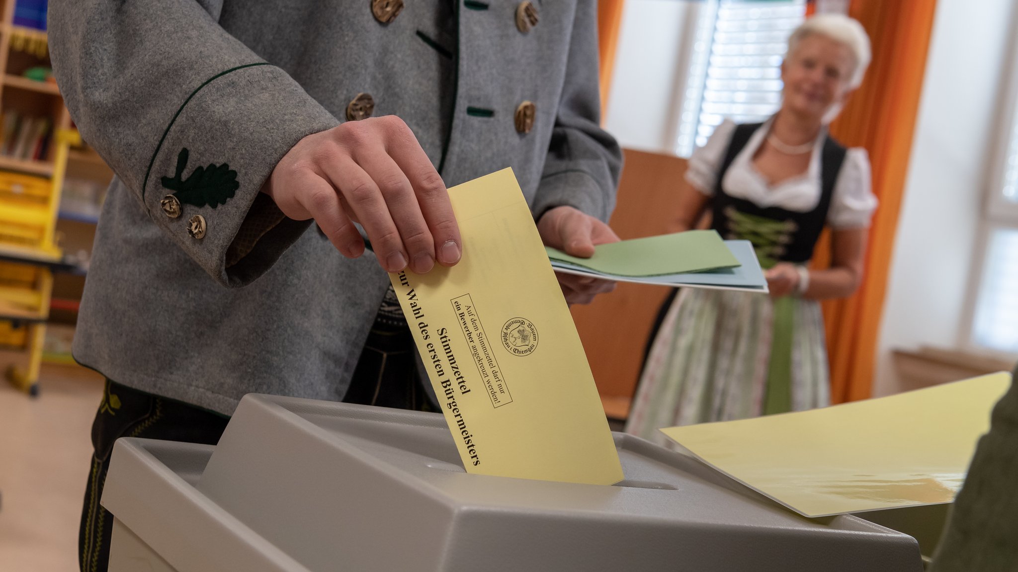 Männer und Frauen in regionaler Tracht bei der Kommunalwahl 