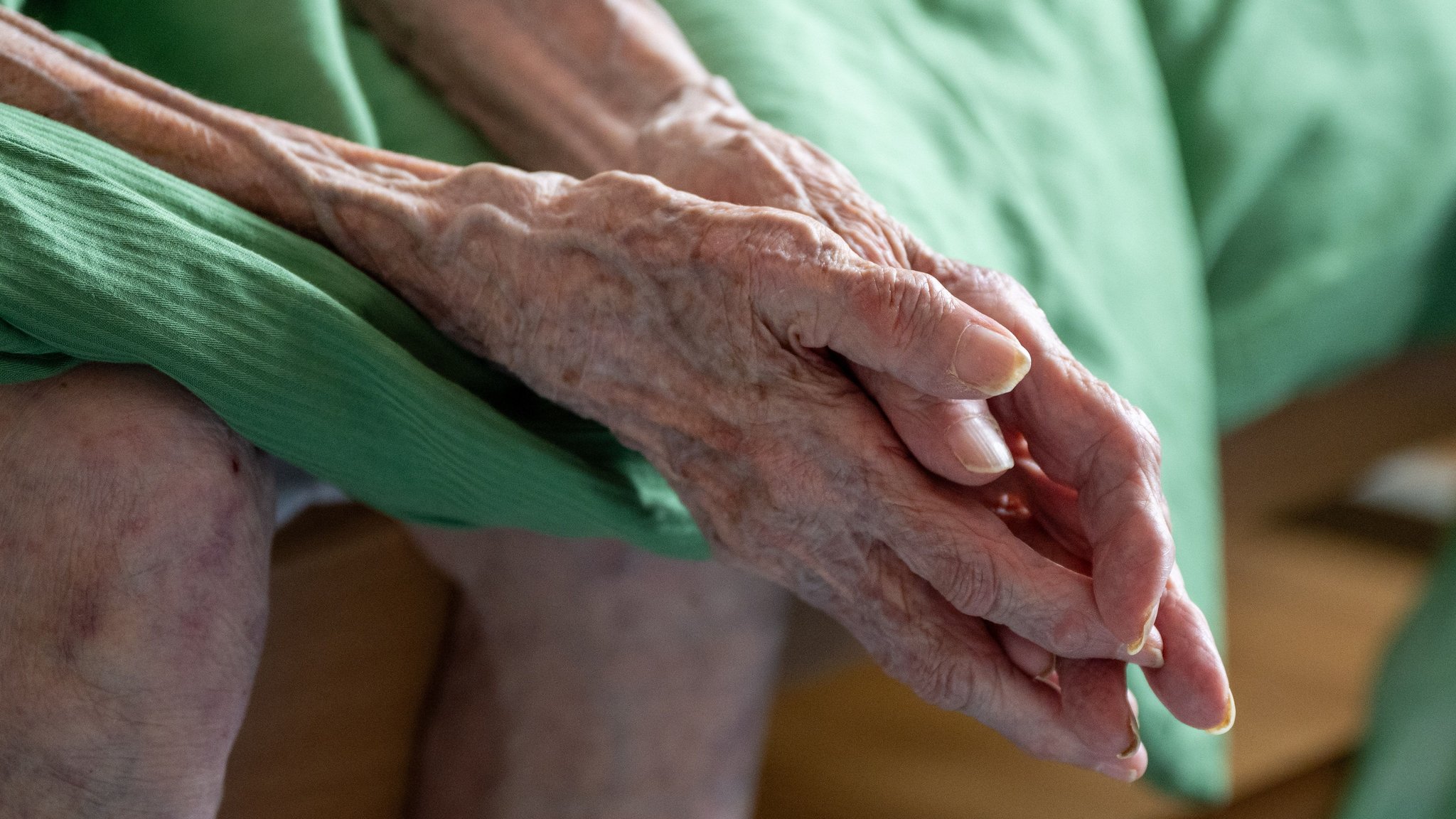 (Symbolbild) Eine pflegebedürftige Seniorin sitzt auf ihrem Bett. | Bild: dpa-Bildfunk/Monika Skolimowska (Symbolbild) Eine pflegebedürftige Seniorin sitzt auf ihrem Bett.