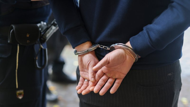 Mann wird mit angelegten Handschellen von Polizei geführt. | Bild: picture alliance/Christoph Reichwein Mann wird mit angelegten Handschellen von Polizei geführt.