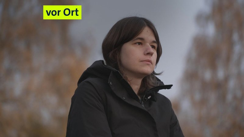 Eine Frau mit einer schwarzen Jacke und braunen Haaren guckt in die Ferne. | Bild: BR Eine Frau mit einer schwarzen Jacke und braunen Haaren guckt in die Ferne.