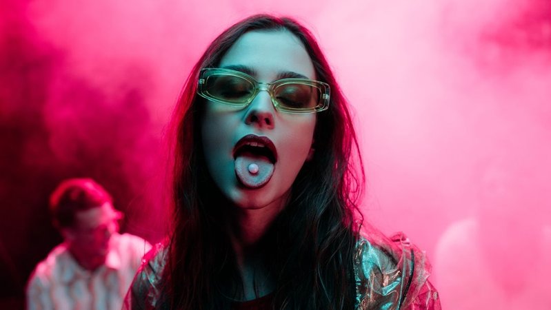 Symbolbild: Eine junge Frau mit einer Pille auf der Zunge. | Bild: stock.adobe.com/LIGHTFIELD STUDIOS Symbolbild: Eine junge Frau mit einer Pille auf der Zunge.