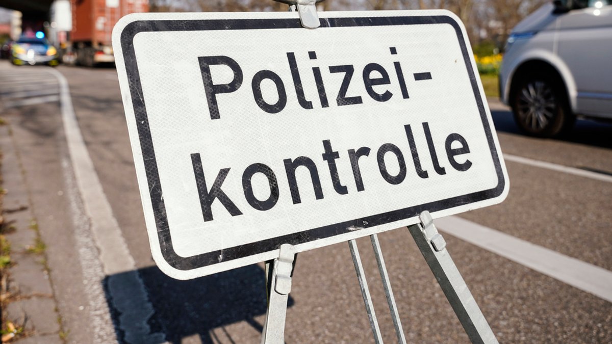 Ein Schild mit der Aufschrift "Polizeikontrolle" steht an einer Bundesstraße (Symbolbild)
