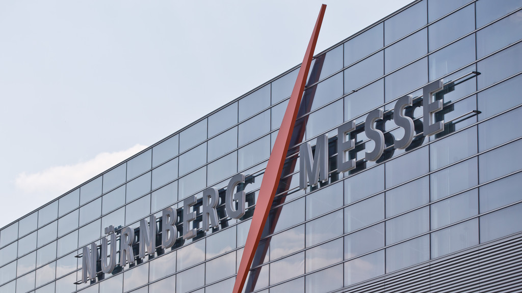 Das Logo der NürnbergMesse an der Glasfassade einer Halle