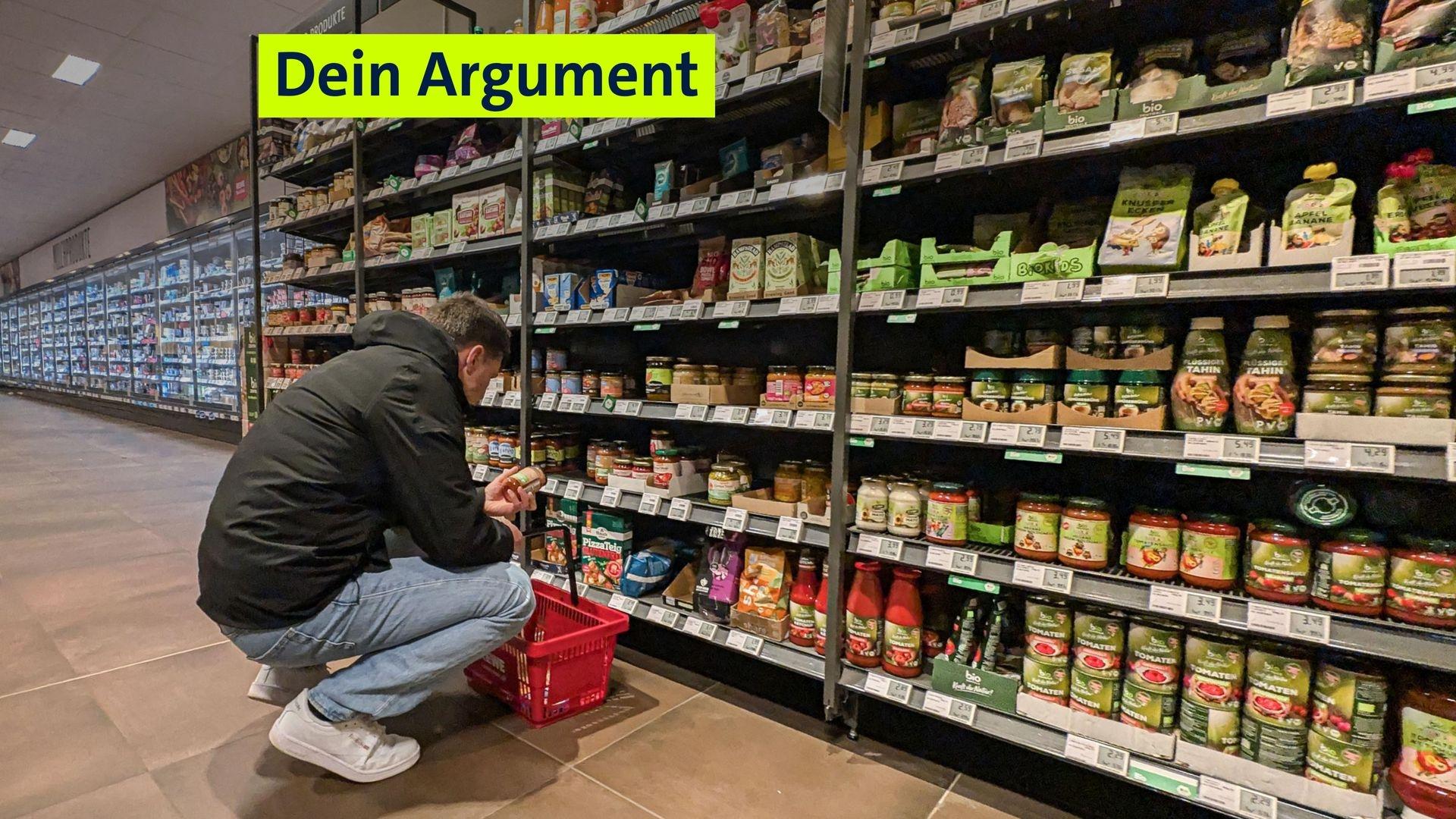 Ein Mann schaut sich in einem Supermarkt eine Produkt an. Wer wissen will, was in den Produkten im Supermarkt steckt, muss sich das Kleingedruckte anschauen.