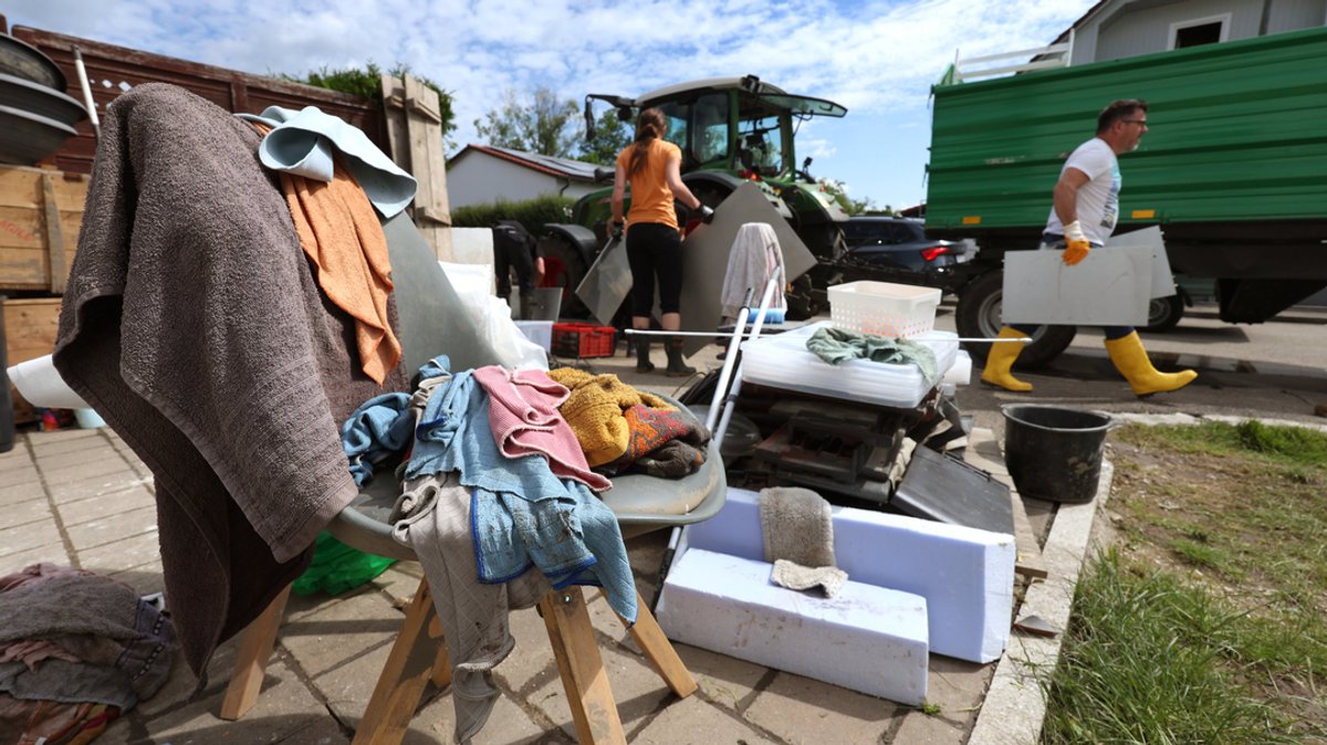 Baar-Ebenhausen: Anwohner und Helfer laden vom Hochwasser zerstörte Einrichtungsgegenstände auf einen Anhänger.