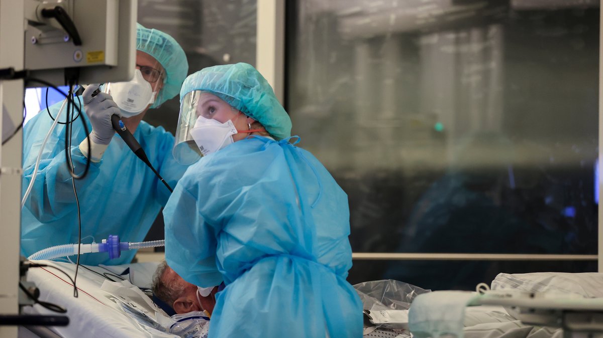 Ein Facharzt und eine Intensivpflegerin führen 2021 eine Bronchoskopie an einem intubierten Covid-19-Patienten auf der Intensivstation der Leipziger Uniklinik durch. ​