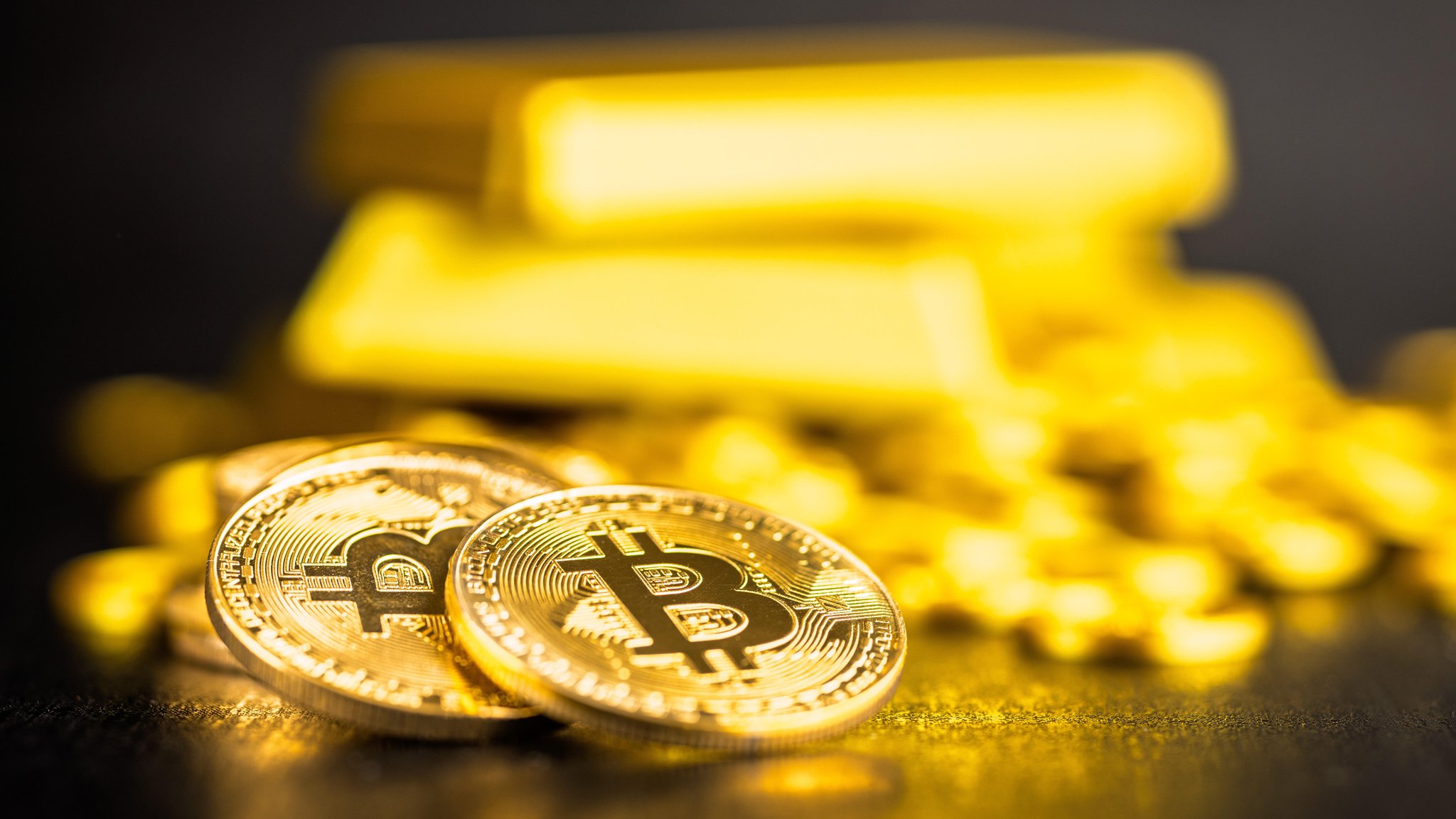 Bitcoin in Gold mit Goldbarren (Symbolbild)