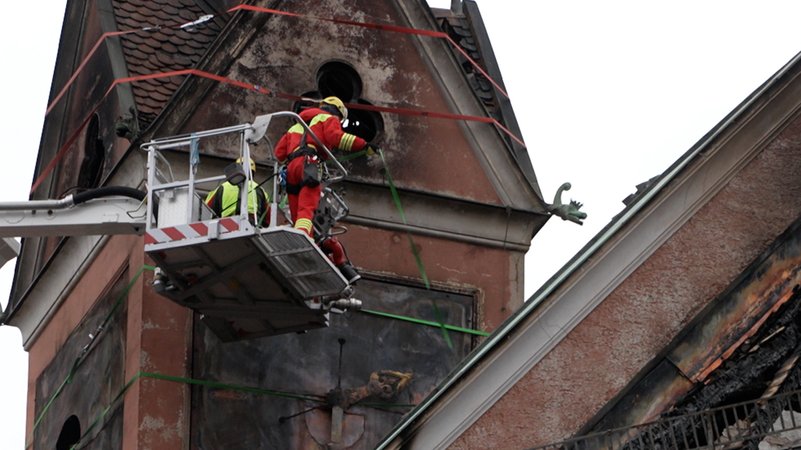 Nach dem Brand im Münchner Seniorenheim Vincentinum an Heiligabend droht jetzt ein Sturm, den historischen Turm weiter zu beschädigen. Die Feuerwehr war vor Ort, um an dem durch den Brand geschädigten Gebäudeteil Sicherungsarbeiten durchzuführen. | Bild: BR Nach dem Brand im Münchner Seniorenheim Vincentinum an Heiligabend droht jetzt ein Sturm, den historischen Turm weiter zu beschädigen. Die Feuerwehr war vor Ort, um an dem durch den Brand geschädigten Gebäudeteil Sicherungsarbeiten durchzuführen.