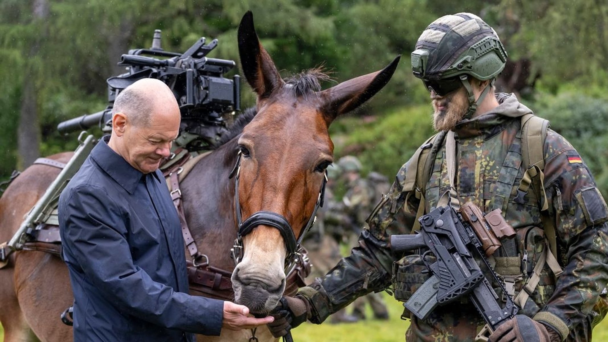 Bundeskanzler Scholz mit einem Gebirgsjäger und einem Lastenmuli