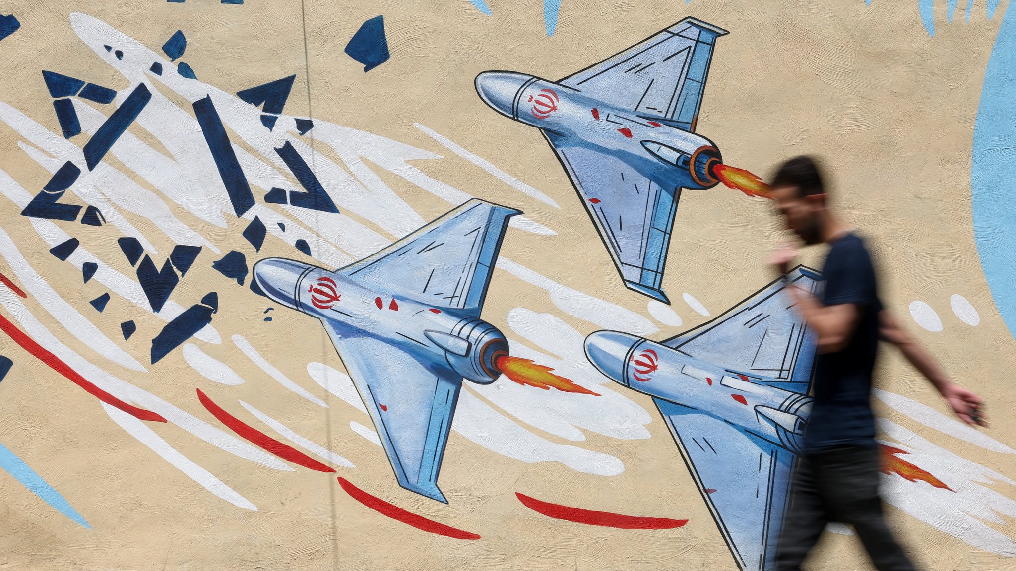 An Iranian man walks next to an anti-Israeli mural on a street in Tehran | Bild: Majid Asgaripour/WANA (West Asia News Agency) via REUTERS An Iranian man walks next to an anti-Israeli mural on a street in Tehran