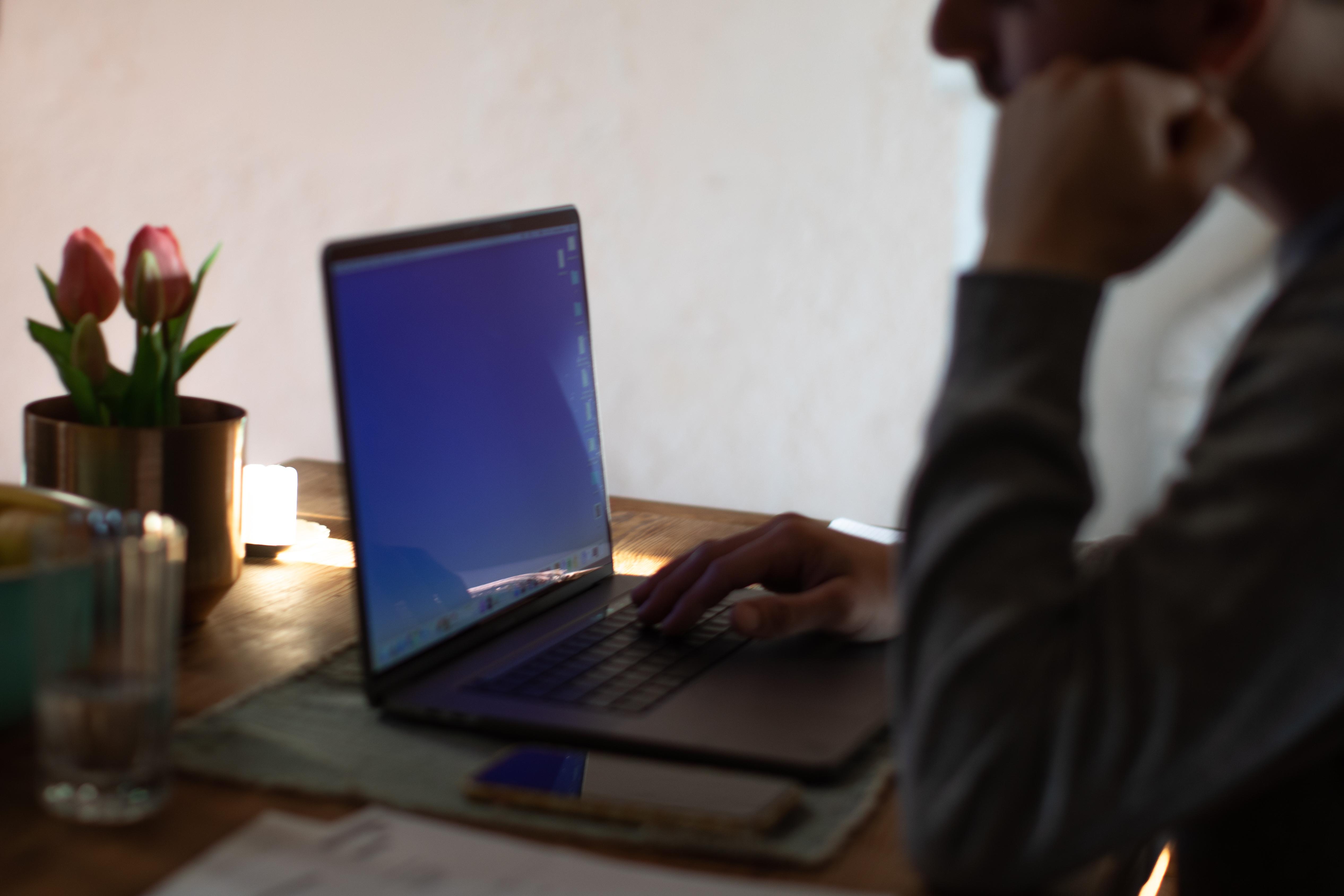 Ein Mann sitzt am Laptop