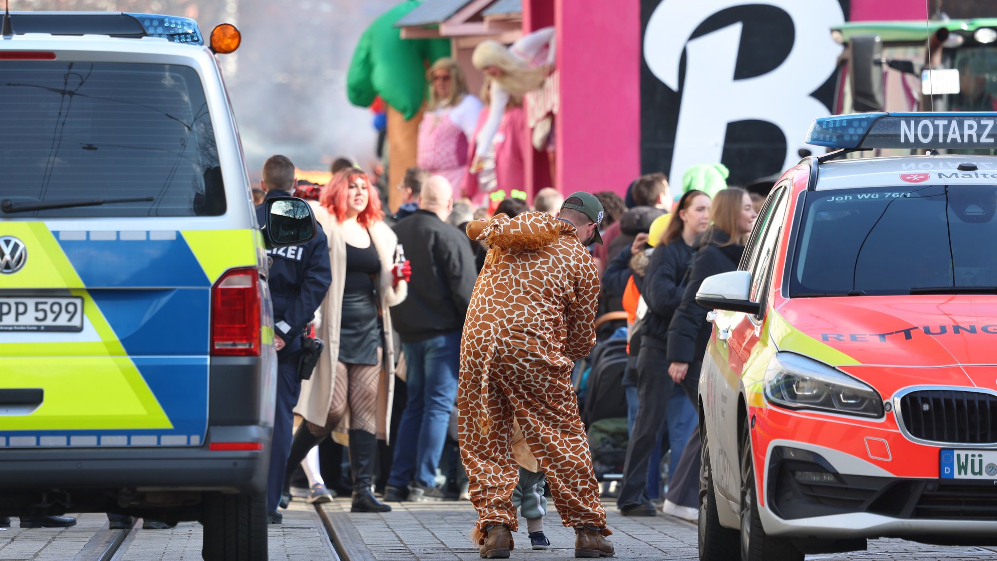 Ein Polizei- und ein Notarztwagen stehen am Rande des Faschingszuges in Würzburg.