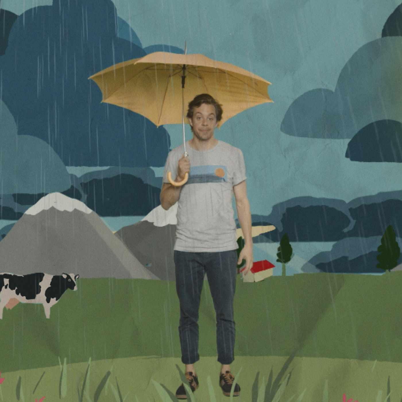 Tobi steht mit einem Regenschirm im Regen.