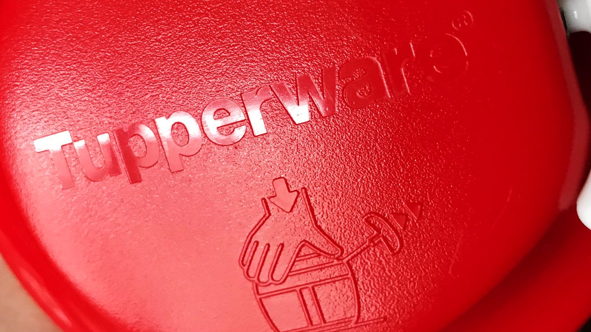 Der Schriftzug "Tupperware" ist auf dem Deckel eines Zwiebelschneiders zu sehen.