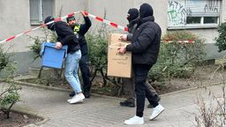 Ermittler gehen mit Kisten und Kartons in das Wohnhaus der früheren RAF-Terroristin Daniela Klette in Berlin. | Bild:dpa-Bildfunk/Paul Zinken