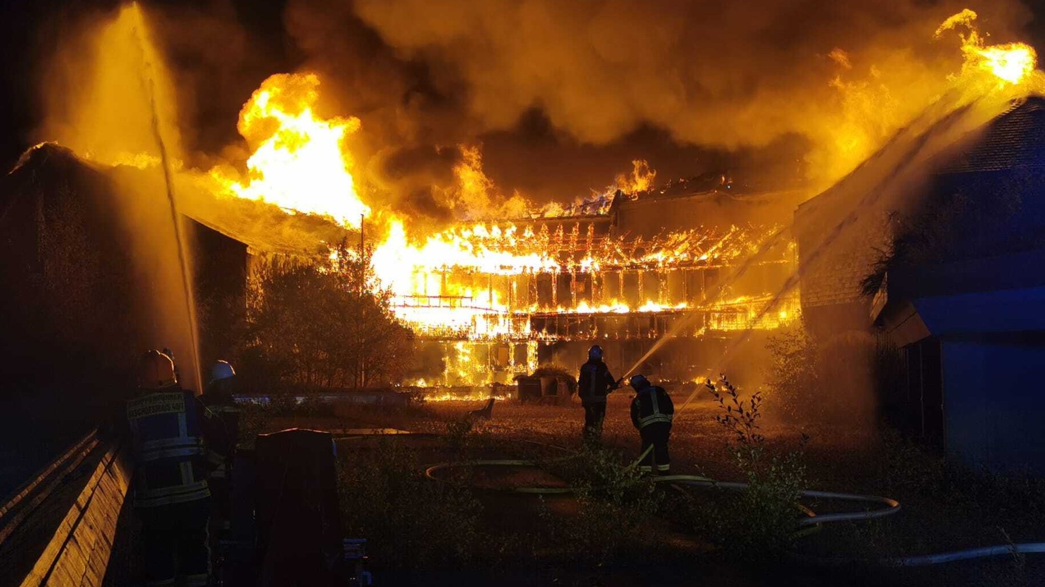 Einsatzkräfte der Feuerwehr löschen den Brand in einem alten Hotelkomplex.