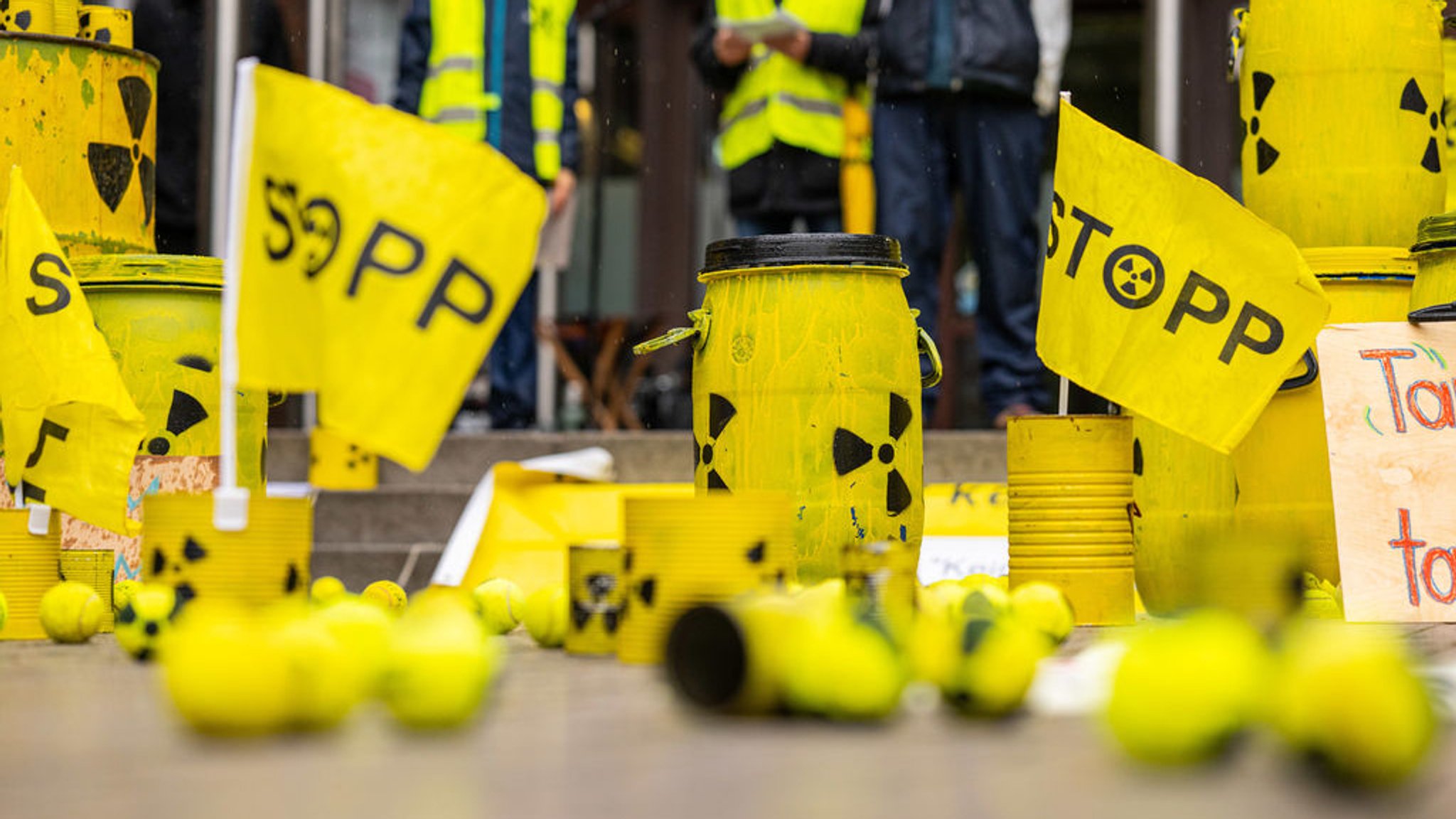 Bei der Kundgebung und Demonstration gegen die geplanten Castortransporte nach Ahaus, stehen mehrere gelbe Behälter mit einem Atomsymbol und kleine Fähnchen mit der Aufschrift: ·STOPP· auf dem Rathausplatz. 41 Initiativen haben zur Demo zur Transportstrecke aufgerufen. | Bild: dpa-Bildfunk/Guido Kirchner Bei der Kundgebung und Demonstration gegen die geplanten Castortransporte nach Ahaus, stehen mehrere gelbe Behälter mit einem Atomsymbol und kleine Fähnchen mit der Aufschrift: ·STOPP· auf dem Rathausplatz. 41 Initiativen haben zur Demo zur Transportstrecke aufgerufen.