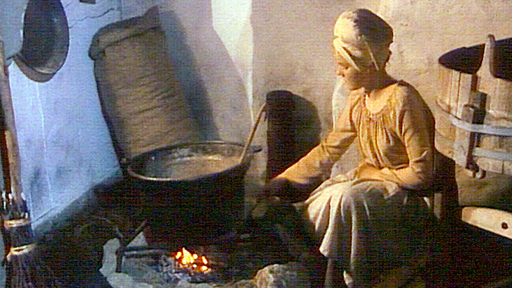 Gemälde einer Frau an einer Feuerstelle 