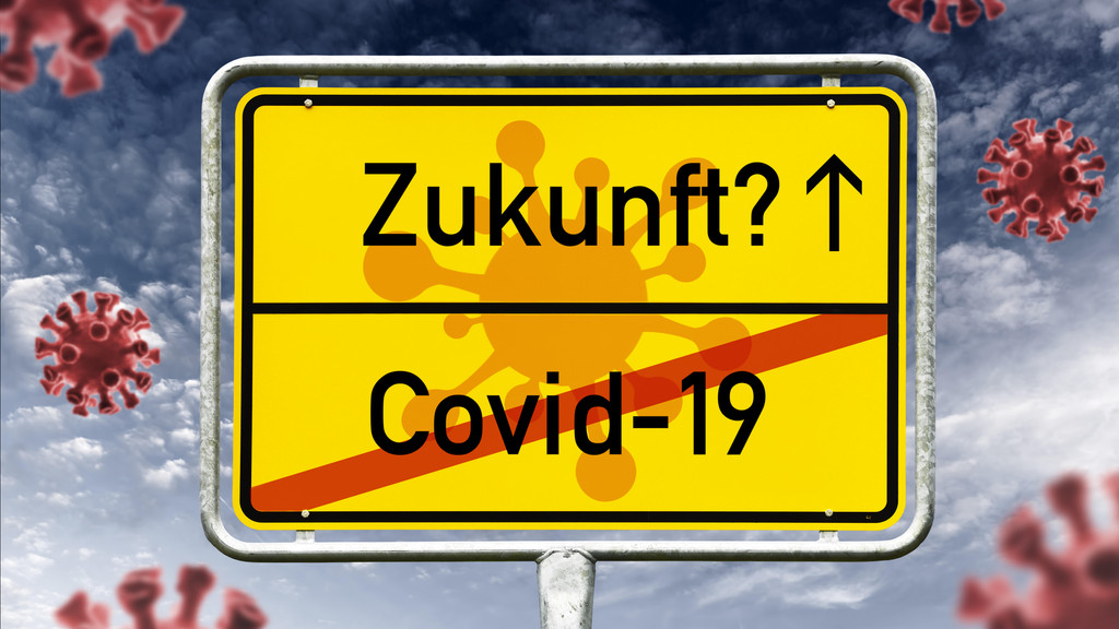 Ein Gemeindeschild zeigt statt Ortsnamen das Wort "Zukunft" und einen durchgestrichenen Covid-19-Schriftzug.
