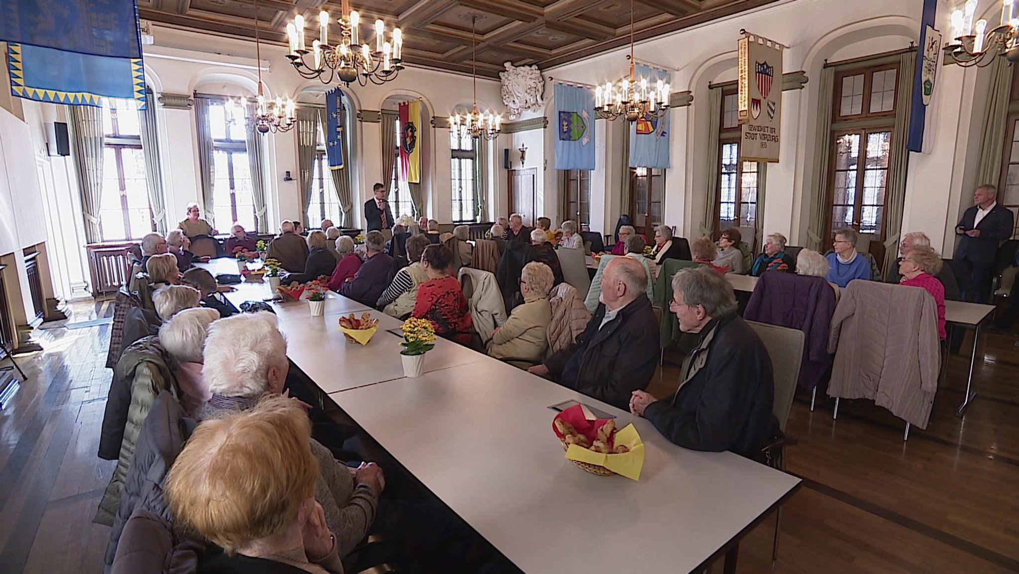 Frauen und Männer, die die Bombardierung von Würzburg erlebt haben sitzen im Rathaus Würzburg.