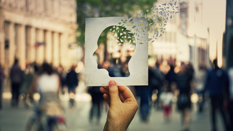 Symbolbild Demenz: Ein Mann hält ein Blatt Papier mit der Silhouette eines Kopfes, der sich langsam in kleine Papierschnipsel auflöst. | Bild: stock.adobe.com/1STunningART Symbolbild Demenz: Ein Mann hält ein Blatt Papier mit der Silhouette eines Kopfes, der sich langsam in kleine Papierschnipsel auflöst.