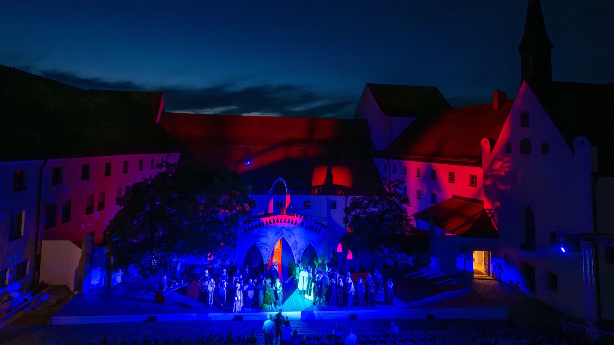 Zahlreiche Darsteller stehen im Hof des Herzogsschlosses während einer Probe der Agnes Bernauer Festspiele auf der Bühne.