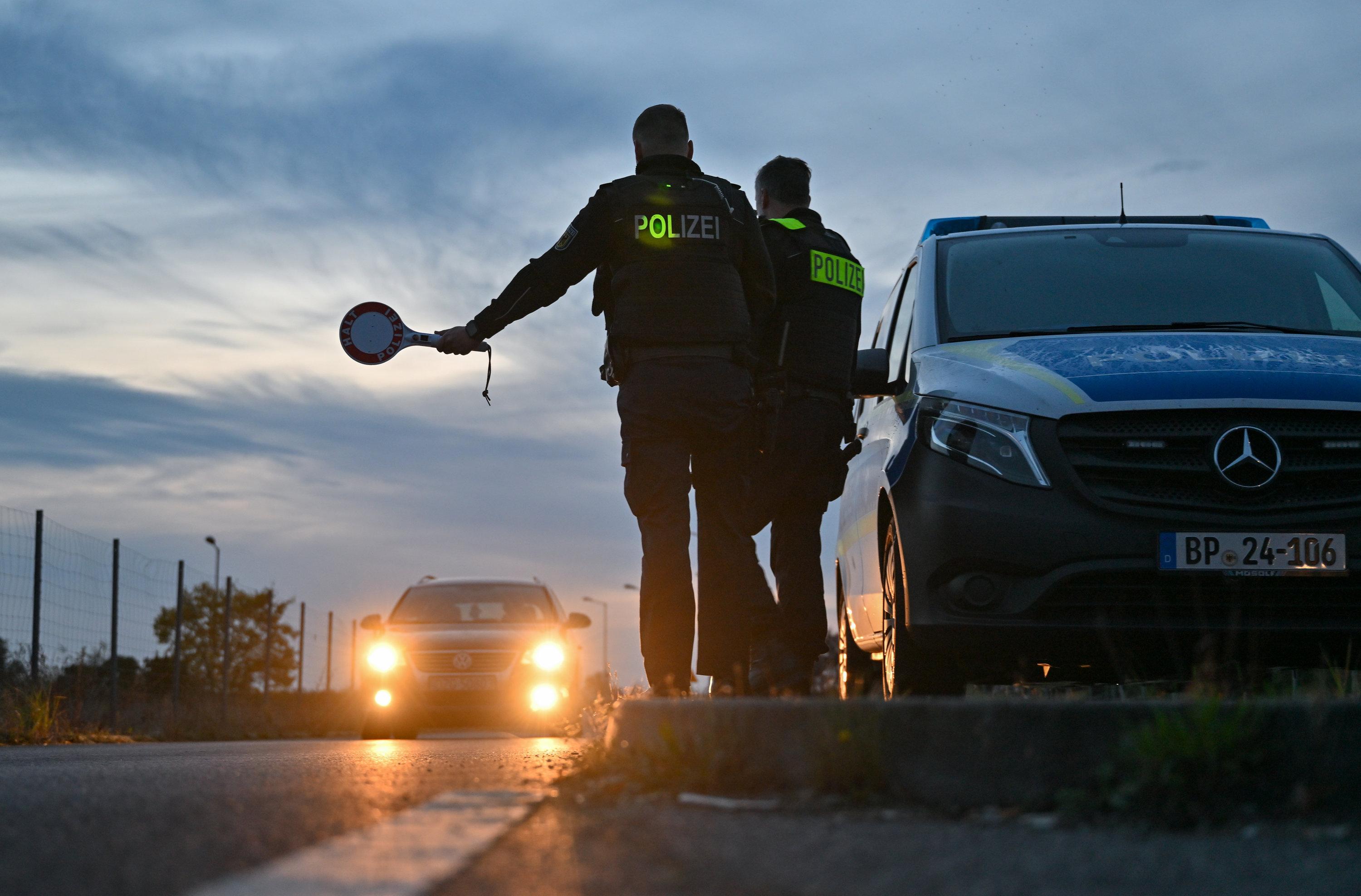 Symbolbild: Beamte der Bundespolizei kontrollieren ein Fahrzeug beim Grenzübertritt nach Deutschland.