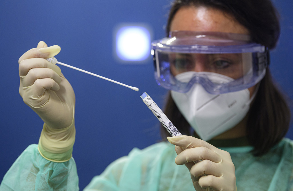 Eine Frau hält einen Abstrich für einen Coronavirus-Test in den Händen. 