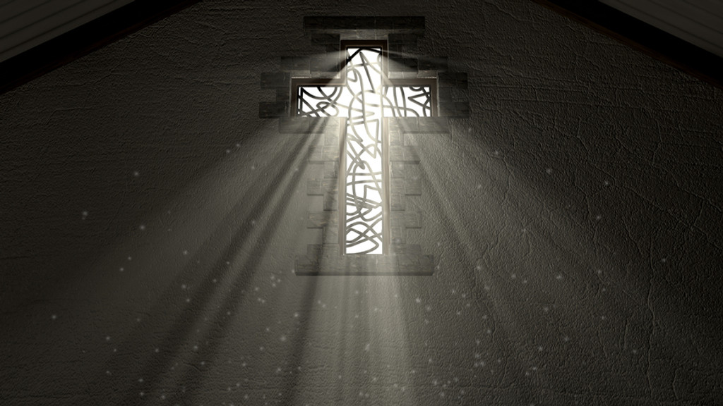 Licht scheint durch ein Fenster in Kreuz-Form.