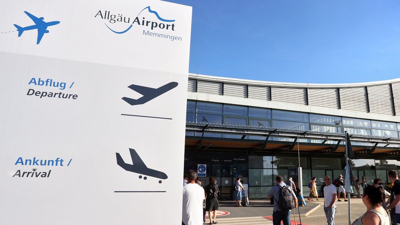 Fluggäste stehen vor dem Terminal des Allgäu Airports 
