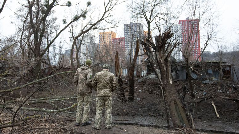 Ukrainische Soldaten vor dem Einschlagkrater einer russischen Rakete in Kiew | Bild:picture alliance / AA | Oleksii Chumachenko