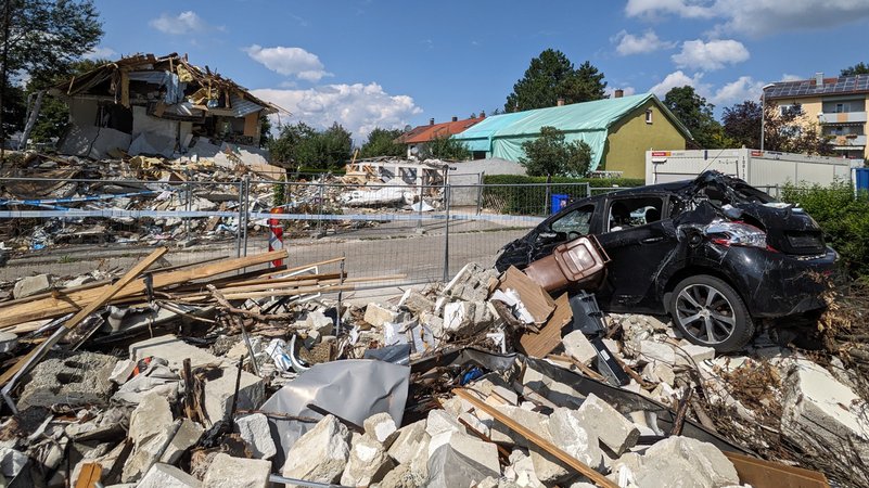 Am 3. September sieht man immer noch die Trümmer des explodierten Hauses, auf den Trümmern steht ein zerbeulter Pkw. | Bild: BR/Florian Regensburger Am 3. September sieht man immer noch die Trümmer des explodierten Hauses, auf den Trümmern steht ein zerbeulter Pkw.