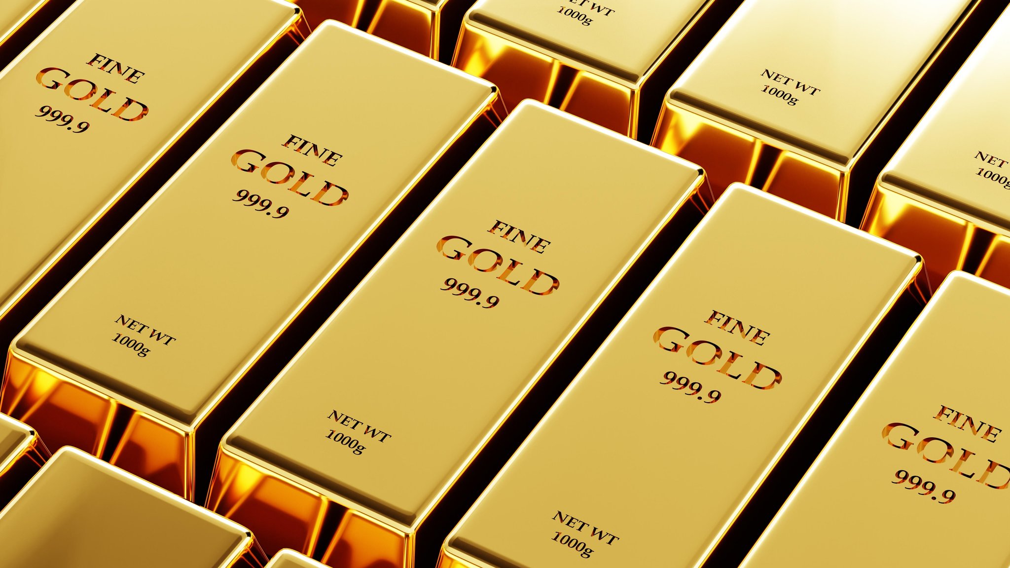 nebeneinander gestapelte Goldbarren 