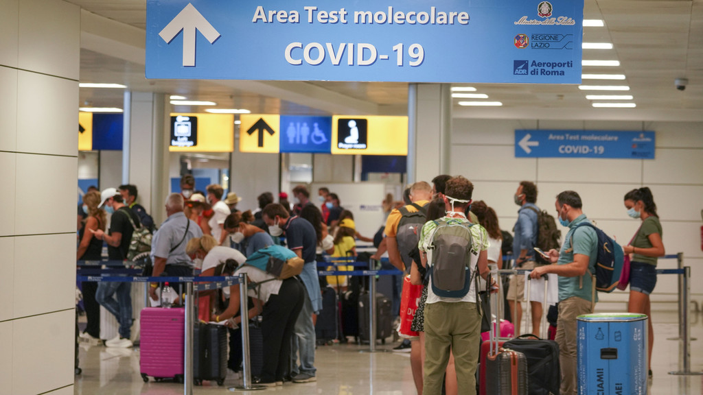Urlauber stehen im Flughafen in einer Schlange für einen Covid-19-Test. 