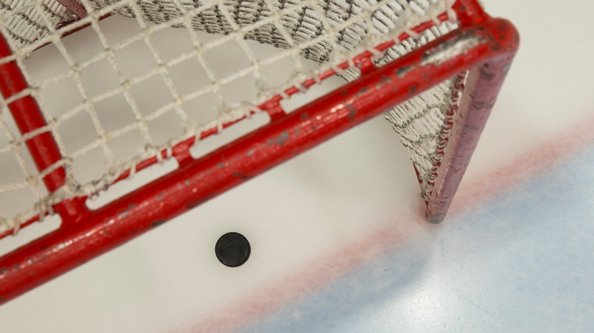 Ein Puck in einem Eishockeytor