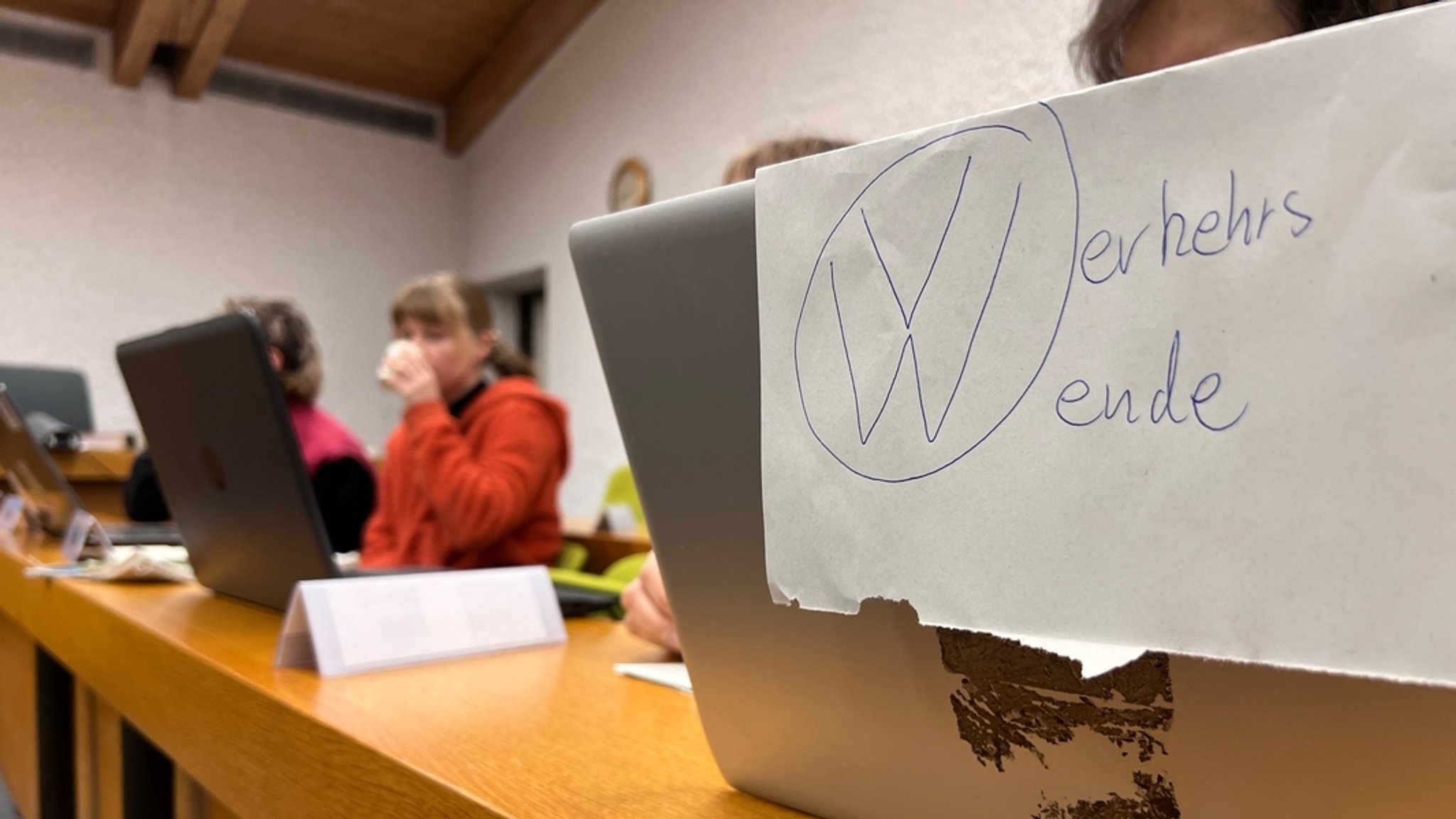 Die vier Angeklagten am Amtsgericht Ebersberg. Im Vordergrund ein Laptop mit der Aufschrift "Verkehrswende".