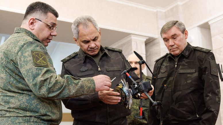 Die Beteiligten in Uniform mit einem Drohnenmodell, links Alexej Wolkow, Chef der Raketen- und Artillerietruppe | Bild:Wadim Sawitzky/Picture Alliance