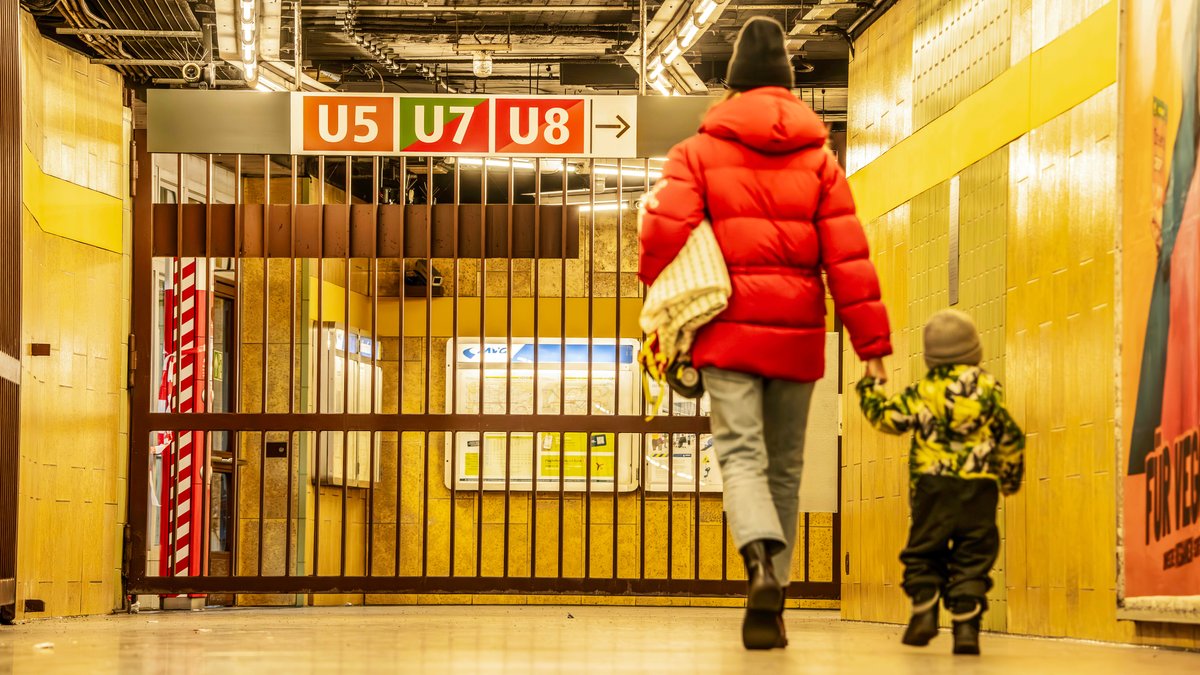 Fahrgäste stehen am Montagmorgen vor einem Gitter in der Münchner U-Bahn