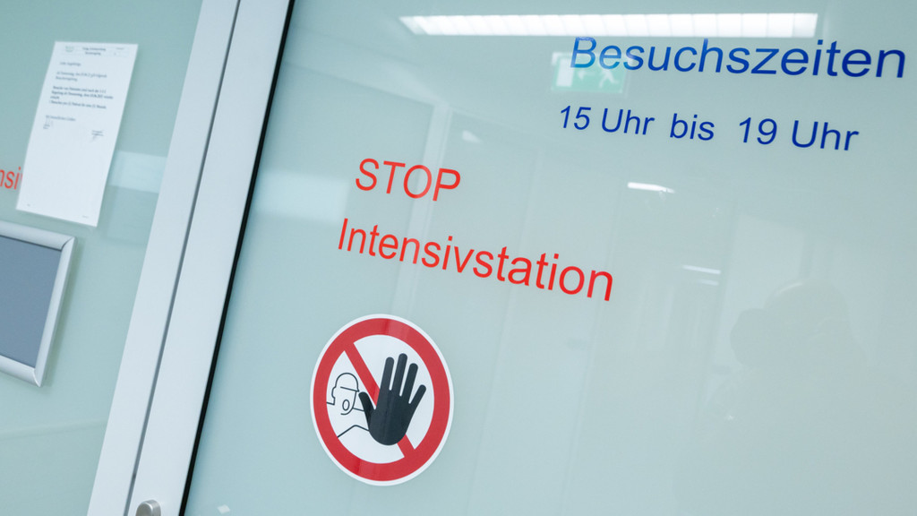 Symbolbild: Die Aufschrift "STOP Intensivstation" klebt an einer automatischen Glastür. 