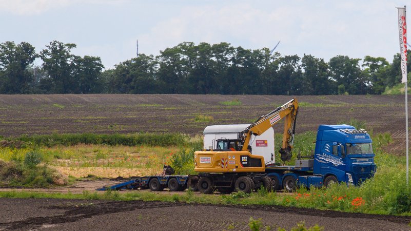 Bagger und LKW auf dem für Intel vorgesehenen Fabrik-Gelände bei Magdeburg | Bild: picture alliance - Klaus-Dietmar Gabbert Bagger und LKW auf dem für Intel vorgesehenen Fabrik-Gelände bei Magdeburg