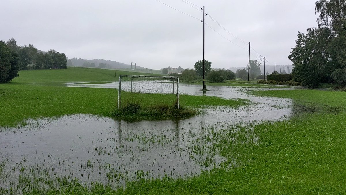 Der Hühnerbach überflutet eine Wiese in Tremmelschwang im Ostallgäu, das Wasser umspült ein einsames Fußballtor.