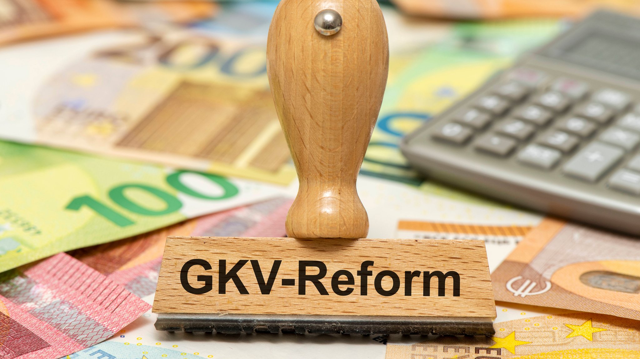 (Symbolbild) Ein Holzstempel ist beschriftet mit dem Aufdruck GKV-Reform als Symbol für notwendige Reformen im Gesundheitssystem.